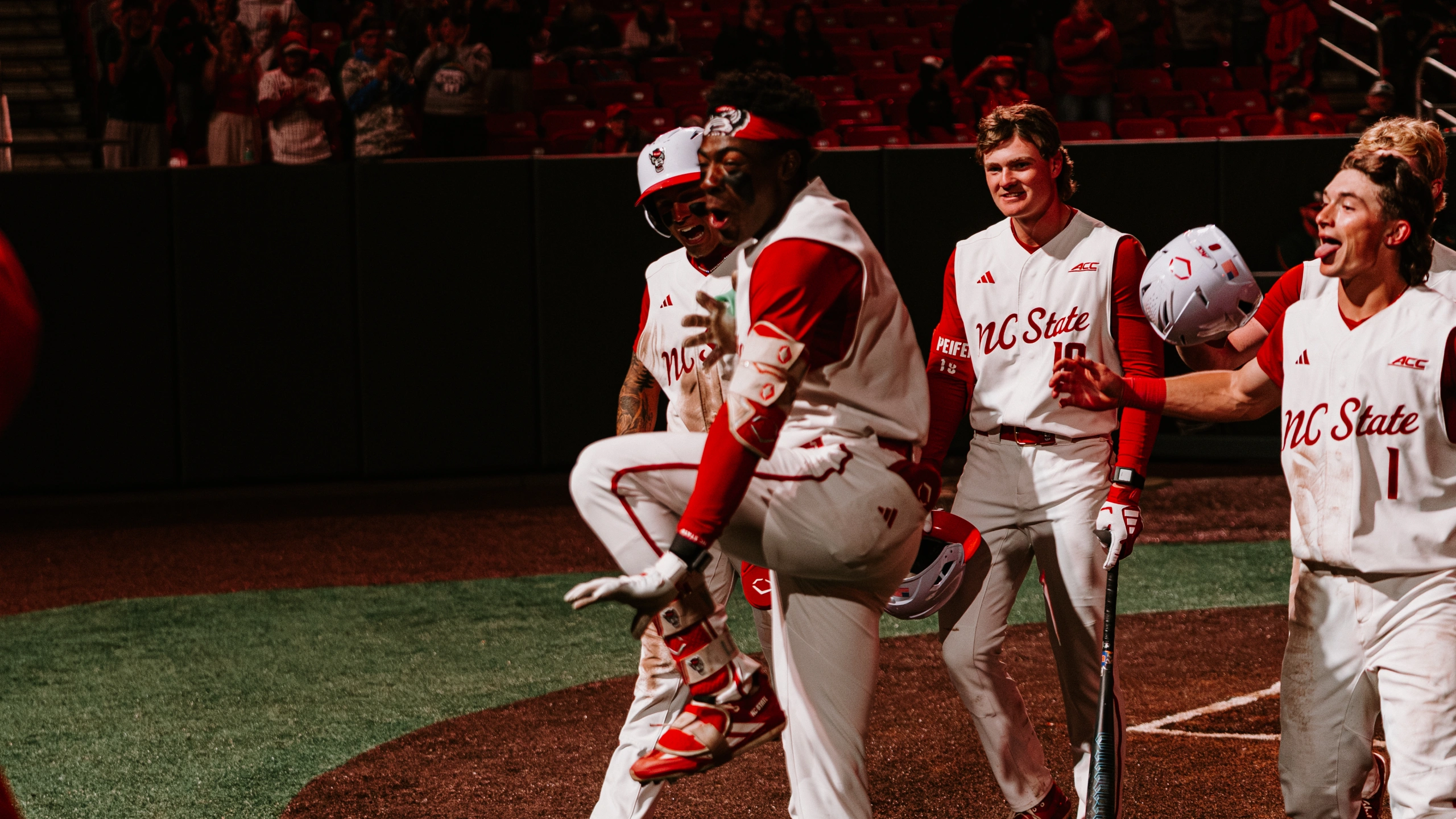 NC State players celebrating on the mound