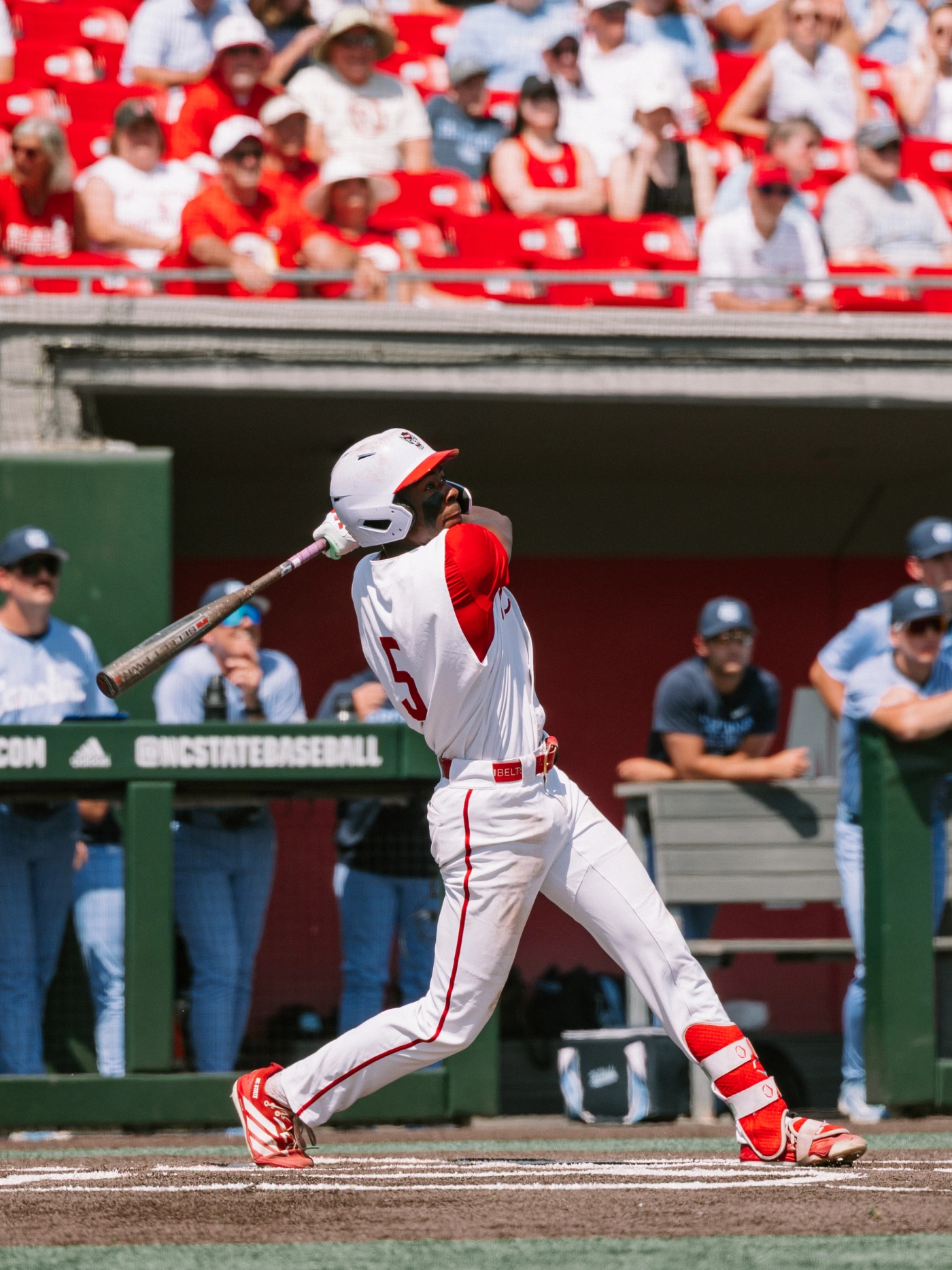 An NC State hitter finishing his swing