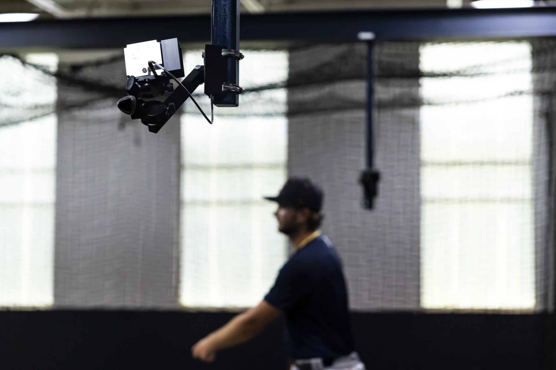 A motion-capture camera mounted above a pitcher in the Charlottesville lab
